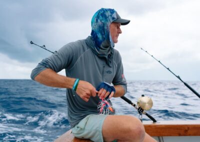 A mate rigs a lure on board a Harbour Island fishing charter with Ocean Fox fishing.